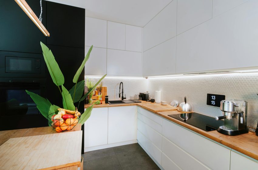 Open concept kuhinja sa belim ugradnim elementima.